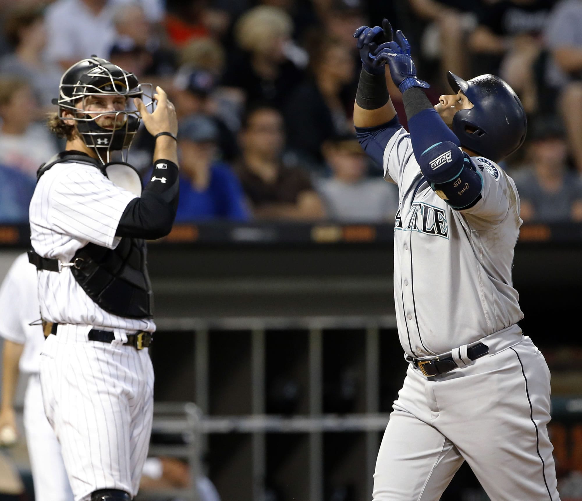Seattle Mariners' Nelson Cruz, right, celebrates after hitting a two-run home run as Chicago White Sox catcher Kevan Smith looks to the field during the sixth inning of a baseball game Saturday, July 15, 2017, in Chicago. (AP Photo/Nam Y.
