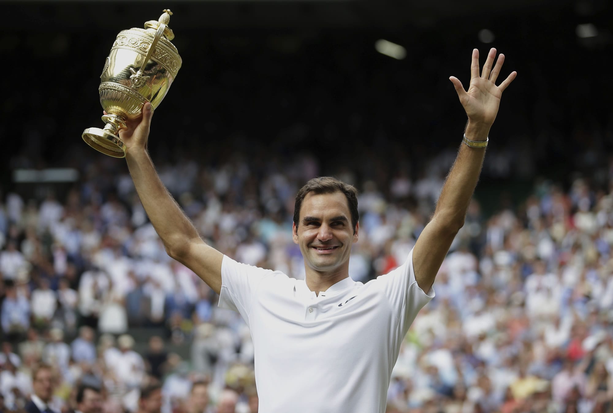 Switzerland's Roger Federer celebrates with the trophy after beating Croatia's Marin Cilic in the Men's Singles final match on day thirteen at the Wimbledon Tennis Championships in London Sunday, July 16, 2017.