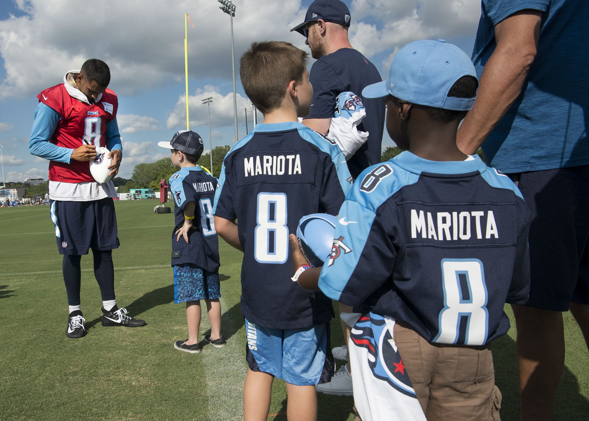 Tennessee Titans quarterback Marcus Mariota (8) signs autographs for kids after the first practice of NFL football training camp, Saturday, July 29, 2017, in Nashville, Tenn.