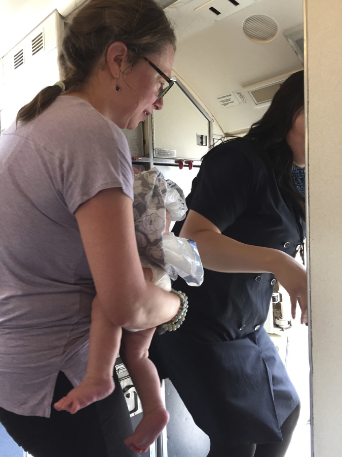 This June 22, 2017 photo provided by Maria de Los Angeles-Baida shows Emily France with her 4-month-old son Owen in Denver. France who says the infant overheated on a delayed United Airlines flight at Denver’s airport, has hired an attorney and hopes the Federal Aviation Administration takes note.