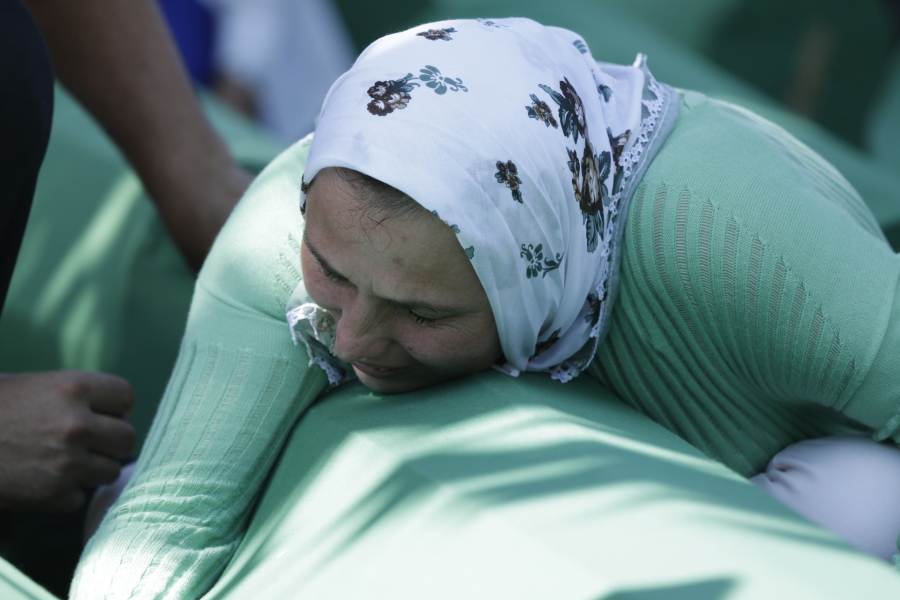 A Bosnian Muslim woman cries near the coffin of her relative during a funeral ceremony for dozens of newly identified victims of the 1995 massacre, at the memorial centre of Potocari near Srebrenica northeast of Sarajevo, Bosnia, on Tuesday. Twenty two years ago, on July 11, 1995, Serb troops overran the eastern Bosnian Muslim enclave of Srebrenica and executed some 8,000 Muslim men and boys, which international courts have labeled as an act of genocide.