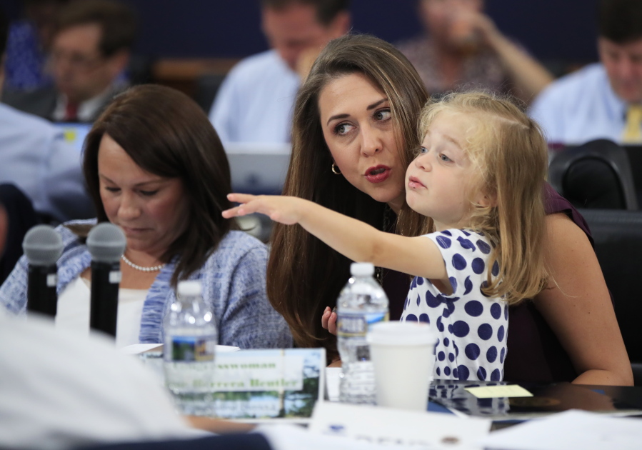 Rep. Jaime Herrera Beutler, R-Battle Ground, holds her daughter, Abigail, during a markup hearing held by the House Appropriations Committee on Wednesday on Capitol Hill. Rep. Martha Roby, R-Ala., is seated next to Herrera Beutler.