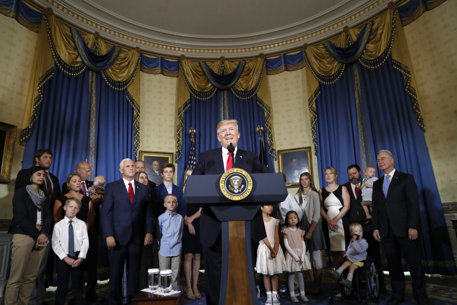 President Donald Trump, accompanied by Vice President Mike Pence, Health and Human Services Secretary Tom Price, and others, speaks about healthcare, Monday, July 24, 2017, in the Blue Room of the White House in Washington.
