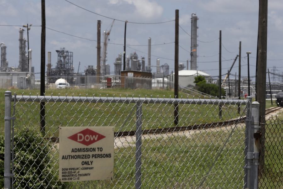 A sign is posted on a roadside fence outside a Dow Chemicals plant in Freeport, Texas.