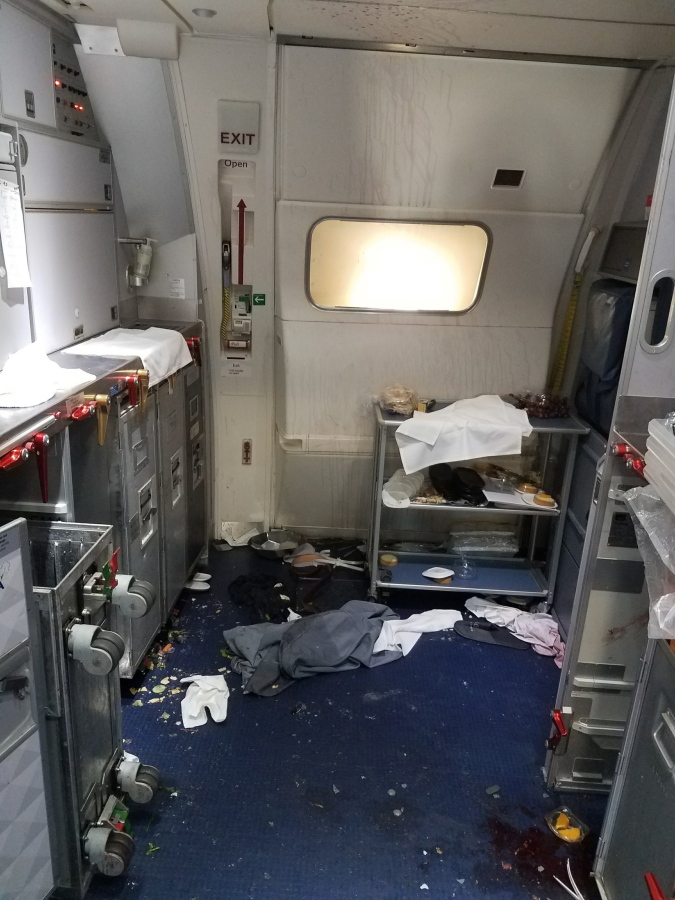 The aftermath of a cabin July 7 on Delta Flight 129 from Seattle to Beijing, after authorities say flight attendants struggled with Joseph Daniel Hudek IV, a passenger who lunged for an exit door. He’s been indicted on five federal charges. FBI via U.S.
