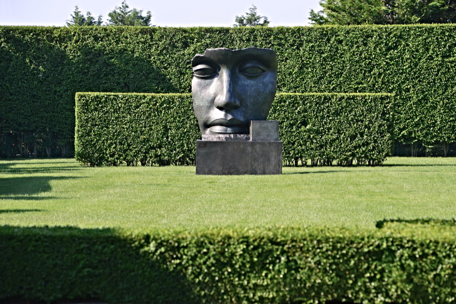 This undated photo provided by The Monacelli Press shows “Per Adriano” by sculptor Igor Mitoraj in a residential garden on the east end of Long Island in New York. The garden was designed by landscape architect Edmund Hollander.