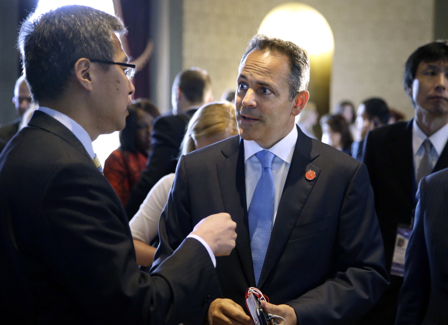 Kentucky Gov. Matt Bevin, right, speaks with a member of the Chinese delegation at the China General Chamber of Commerce luncheon during the first day of the National Governor’s Association meeting Thursday, July 13, 2017, in Providence, R.I.