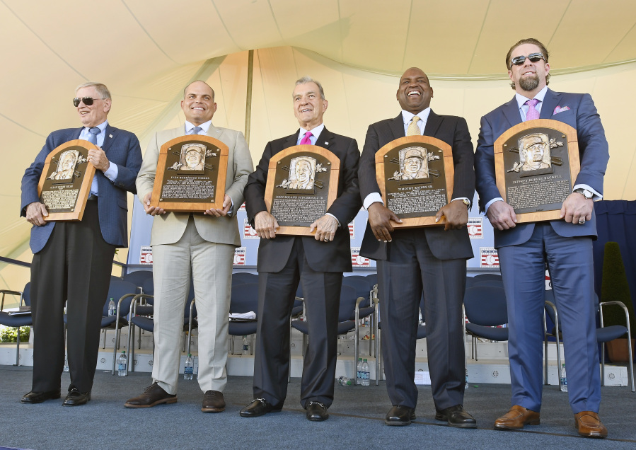 Newly-inducted National Baseball Hall of Famers from left, Bud Selig, Ivan Rodriguez, John Schuer, Tim Raines Sr., and Jeff Bagwell hold their plaques after an induction ceremony at the Clark Sports Center on Sunday, July 30, 2017, in Cooperstown, N.Y.