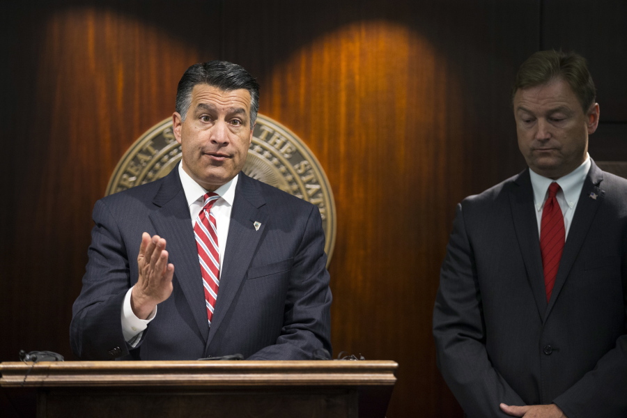Gov. Brian Sandoval, left, and U.S. Sen. Dean Heller, R-Nev., give a news conference June 23 in Las Vegas where the senator announced he will vote no on the proposed GOP healthcare bill. A handful of Republican governors, including Sandoval, who support some of the key pillars of former President Barack Obama’s health care law are among the main reasons Senate leaders cannot persuade enough Republicans to get behind their repeal-and-replace effort.