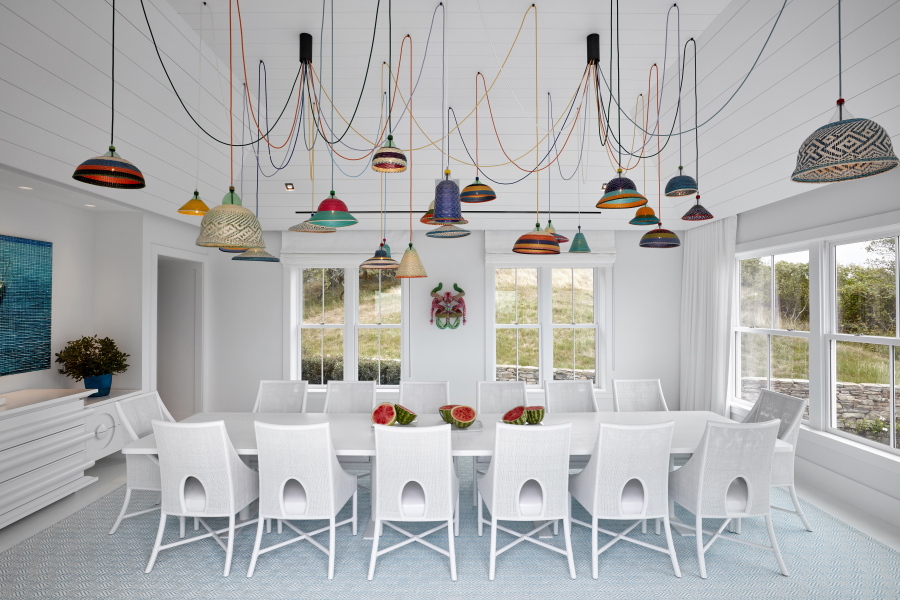 A room in a Montauk, N.Y., beach house in 2016 features Ghislaine Viñas Interior Design’s work. The bold, colorful statement lighting becomes not only illumination but art. Viñas used Alvaro Catalan de Ocon’s PET Lamp chandelier, placing the it in an all-white dining space.