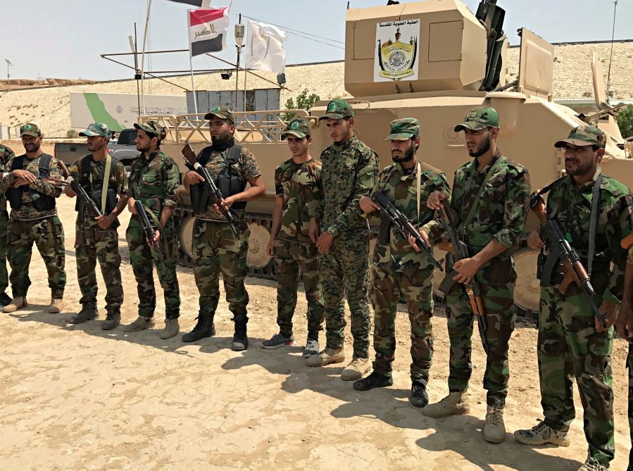 Shiite volunteer fighters from the Imam Ali Brigade, an armed faction with the Iraqi Popular Mobilization Forces, train in their camp in Najaf, 100 miles (160 kilometers) south of Baghdad, Iraq. Iraq’s political, religious and military leaders are debating the future of the country’s powerful Shiite militias after defeating the Islamic State group in Mosul.