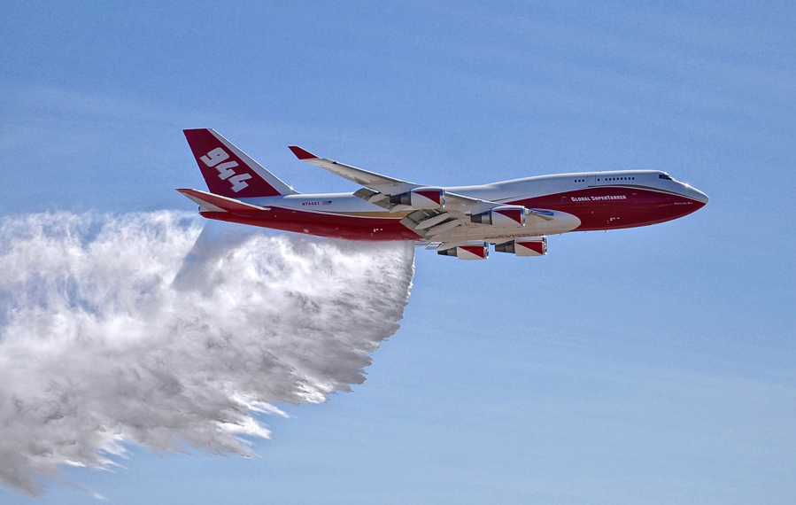 A Boeing 747 makes a demonstration water drop at Colorado Springs Airport in Colorado Springs, Colo. Federal officials have given a giant airtanker capable of carrying 19,200 gallons of liquid approval to fight wildfires in the U.S., but a lack of contracts currently limits the aircraft to California and one county in Colorado.