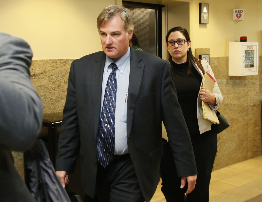 Shannon Kepler, left, arrives with his legal team for his trial in Tulsa, Okla.