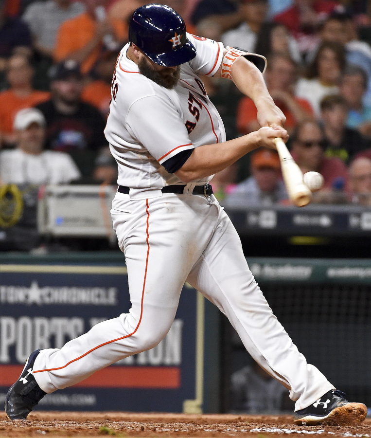 Houston Astros’ Evan Gattis hits a solo home run off Seattle Mariners starting pitcher Sam Gaviglio during the sixth inning of a baseball game, Tuesday, July 18, 2017, in Houston.