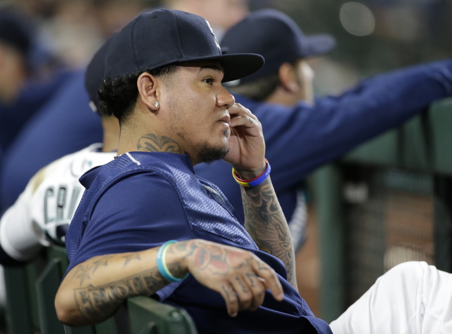 FILE - In this May 31, 2017, file photo, Seattle Mariners pitcher Felix Hernandez, who at this time was on the disabled list, sits in the dugout during a baseball game against the Colorado Rockies,in Seattle. Trying to define who the Seattle Mariners are heading into the second half of the season is a challenge and leaves the club in a difficult spot of only having a short time in July to decide how to move forward for the final two months of the season. (AP Photo/Ted S.