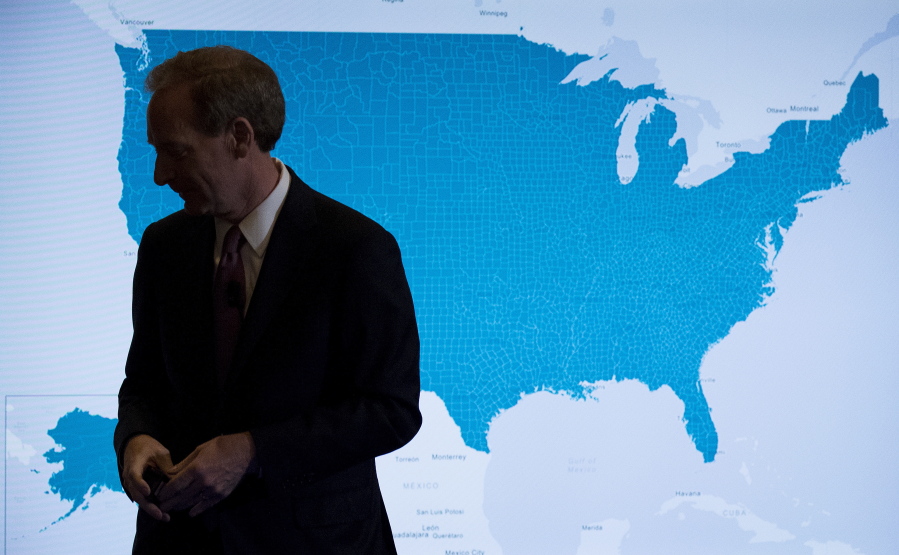 Microsoft President and Chief Legal Officer Brad Smith pauses in front of a monitor displaying the U.S. as he speaks in Washington on Tuesday about Microsoft’s project to bring broadband internet access to rural parts of the United States.