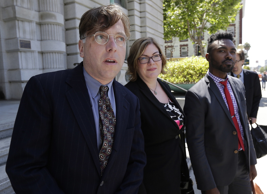 Attorney Andrew Dhuey, from left, representing photographer David Slater, attorney Angela Dunning, representing Blurb, a San Francisco-based self-publishing company, and Trevor Cooper, Legal Counsel at Blurb, speak to reporters outside of the 9th U.S. Circuit Court of Appeals in San Francisco, Wednesday, July 12, 2017. Attorneys for Slater, a wildlife photographer whose camera was used by a monkey to snap selfies, asked a federal appeals court to end a lawsuit seeking to give the animal rights to the photos. People for the Ethical Treatment of Animals sought a court order in 2015 allowing it to administer all proceeds from the photos to benefit the monkey.