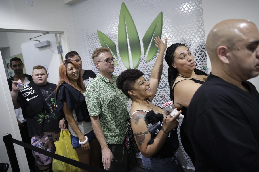 People wait in line at the Essence cannabis dispensary, Saturday, July 1, 2017, in Las Vegas. Nevada dispensaries were legally allowed to sell recreational marijuana starting at 12:01 a.m. Saturday.