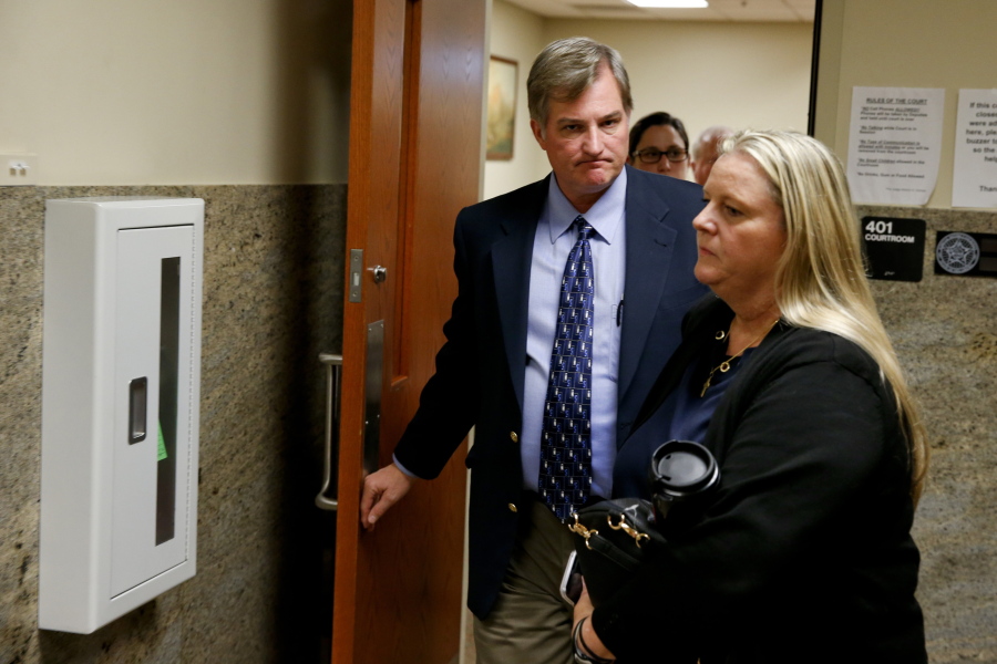 Shannon Kepler walks with his wife, Gina, out of a courtroom after a hung jury verdict was announced at the Tulsa Country Courthouse, Friday, July 7, 2017, in Tulsa, Okla. A third mistrial was declared Friday in the murder case of Kepler, a white former Oklahoma police officer accused in the off-duty fatal shooting of his daughter’s black boyfriend.