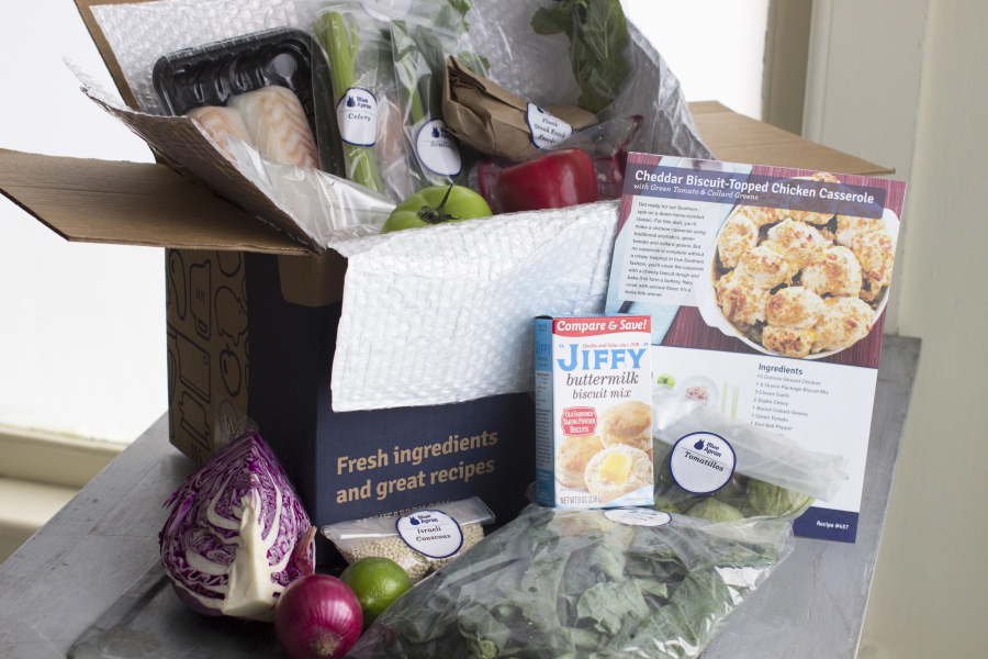 FILE - In this Oct. 6, 2014 file photo, an example of a home delivered meal from Blue Apron seen in Concord, N.H. Despite the old saying, you can buy happiness, especially if you spend it to save yourself time, new research finds.Researchers surveyed more than 6,000 people in four countries and found that people who doled out cash to save them time, housekeeping, grocery delivery services, taxis, were happier than those who don’t.