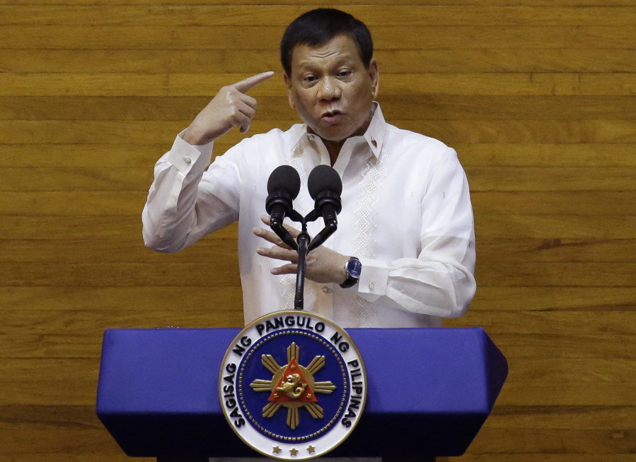 Philippine President Rodrigo Duterte gestures during his second state of the nation address at the House of Representatives in suburban Quezon city, north of Manila, Philippines, Monday July 24, 2017. Duterte said he will not stop his deadly crackdown on illegal drugs and warns that addicts and dealers have two choices: jail or hell.