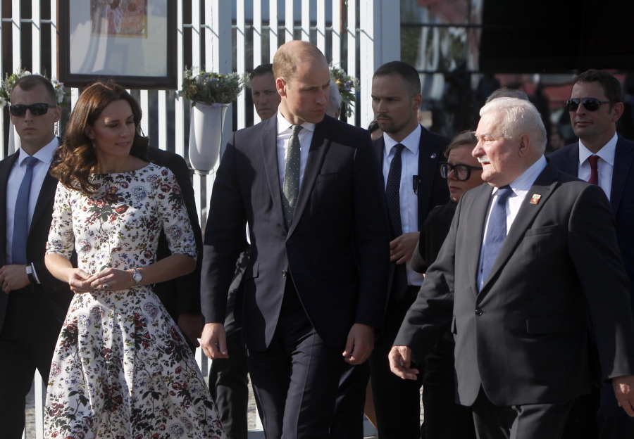 Poland’s former president and legendary Solidarity freedom movement founder Lech Walesa, right, welcomes Britain’s Prince William and Kate, the Duchess of Cambridge, on Tuesday in front of the European Solidarity Center in Gdansk, Poland.