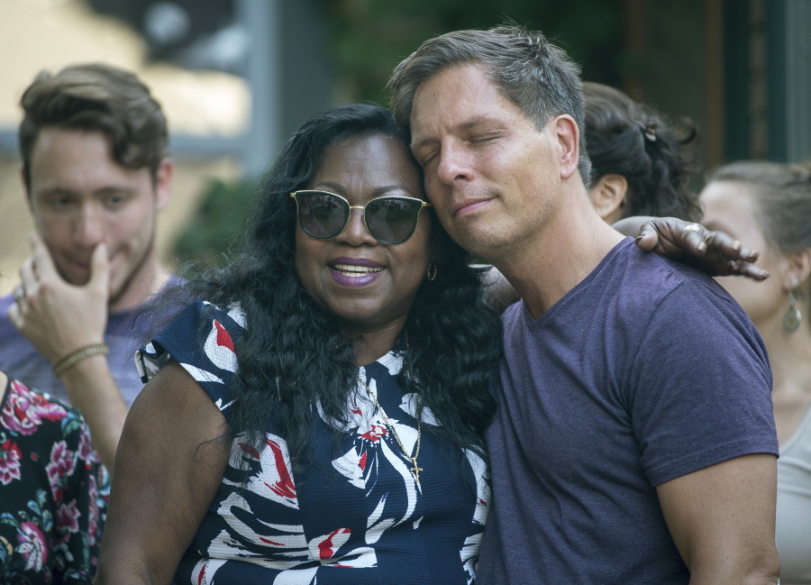 Don Damond, the fiance of Justine Damond, is comforted outside his home by Valerie Castile, the mother of Philando Castile, as demonstrators march by Damond’s home during a march in honor of Justine Damond, Thursday, July 20, 2017, in Minneapolis. Both Philando Castile and Justine Damond were shot and killed by Minneapolis police officers.
