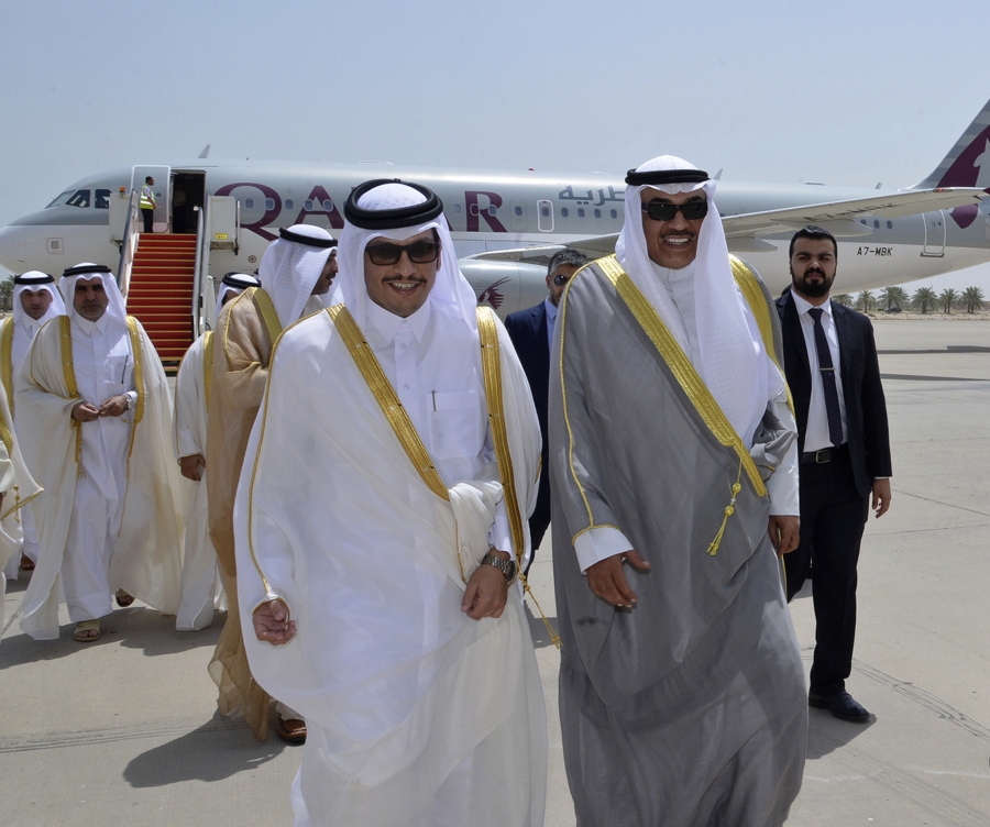 Qatari Foreign Minister Sheikh Mohammed bin Abdulrahman Al Thani, left, and Kuwaiti Foreign Minister Sheikh Sabah Khaled Al Sabah, right, walk together on an airport tarmac, on Al Thani’s arrival in Kuwait. Qatar’s foreign minister, carrying a handwritten letter from the country’s ruling emir arrived in Kuwait amid a diplomatic crisis engulfing his nation.