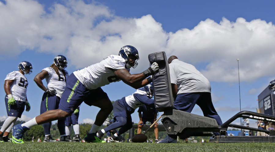 Seattle Seahawks defensive end Shaneil Jenkins hits a blocking sled during an NFL football training camp, Sunday, July 30, 2017, in Renton, Wash. (AP Photo/Ted S.