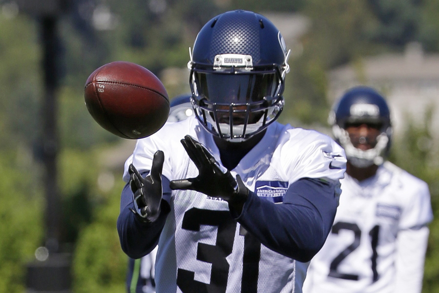 Seattle Seahawks strong safety Kam Chancellor catches the ball during an NFL football training camp, Monday, July 31, 2017, in Renton, Wash. (AP Photo/Ted S.