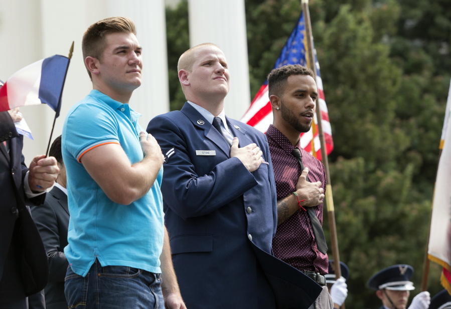 FILE - In this Sept. 11, 2015 file photo, Oregon National Guardsman Alek Skarlatos, left, U.S. Airman Spencer Stone, center, and Anthony Sadler attend a parade held to honor the three Americans who stopped a gunman on a Paris-bound passenger train, in Sacramento, Calif. The three Sacramento-area men who thwarted a terror attack on a French train in 2015 will play themselves in a Clint Eastwood-directed film about their heroic feat. Sadler, Skarlatos, and Stone will star in “15:17 to Paris,” which began production this week.