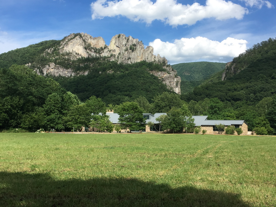 Seneca Rocks rises behind the Monongahela National Forest Discovery Center in eastern West Virginia. The crag draws serious rock climbers though guides say they also bring novices up its easier routes to the summit.