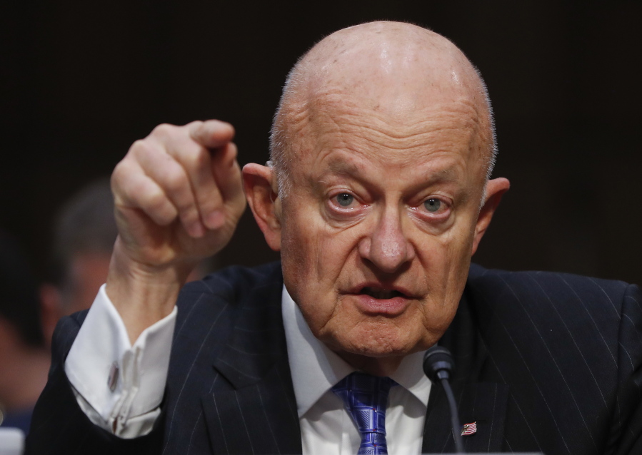 FILE - In this Monday, May 8, 2017, file photo, former National Intelligence Director James Clapper testifies on Capitol Hill in Washington. Two former top intelligence officials are harshly criticizing President Donald Trump for not standing up to Russia for meddling in the presidential election.