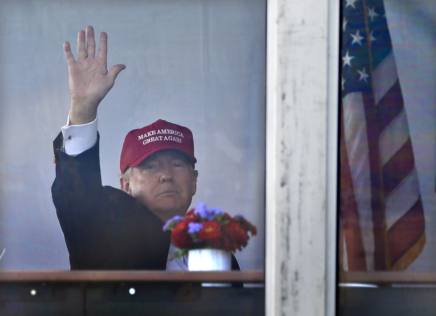 President Donald Trump waves to spectators as he watches the third round of the U.S. Women’s Open Golf tournament from his observation booth, Saturday, July 15, 2017, in Bedminster, N.J.
