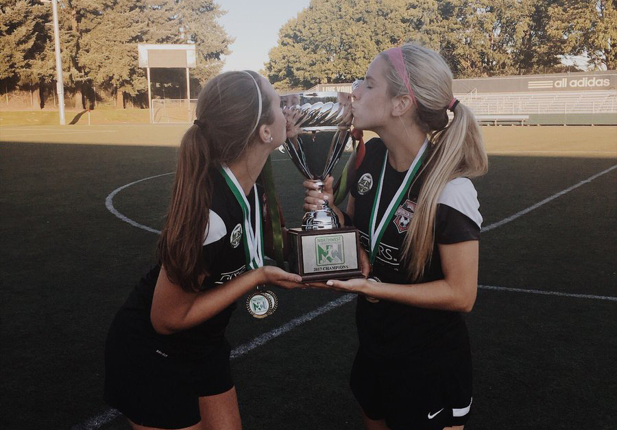 Washington Timbers Brenna Bogle and Abby Bohn kiss the Northwest Premier League Championship trophy after beating Seattle 2-1 on Sunday, July 30, 2017 at Tukwila.