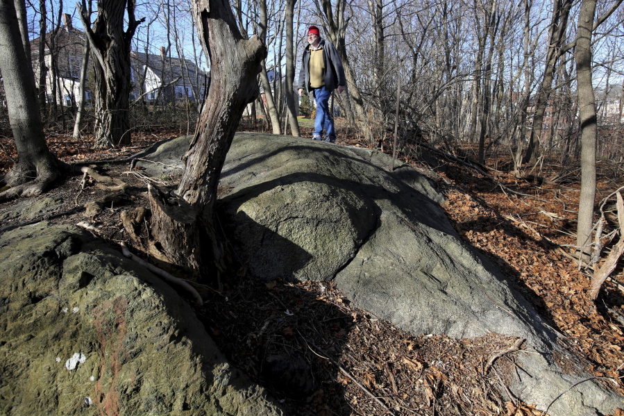 Salem State University history professor Emerson Baker walks Jan. 11, 2016 through an area known as Proctor’s Ledge that he and a team of researchers said is the exact site where innocent people were hanged during the 1692 witch trials in Salem, Mass. Salem and Danvers are holding separate ceremonies Wednesday, to mark the 325th anniversary of the hangings of five women convicted of being witches. Twenty people in all were killed.