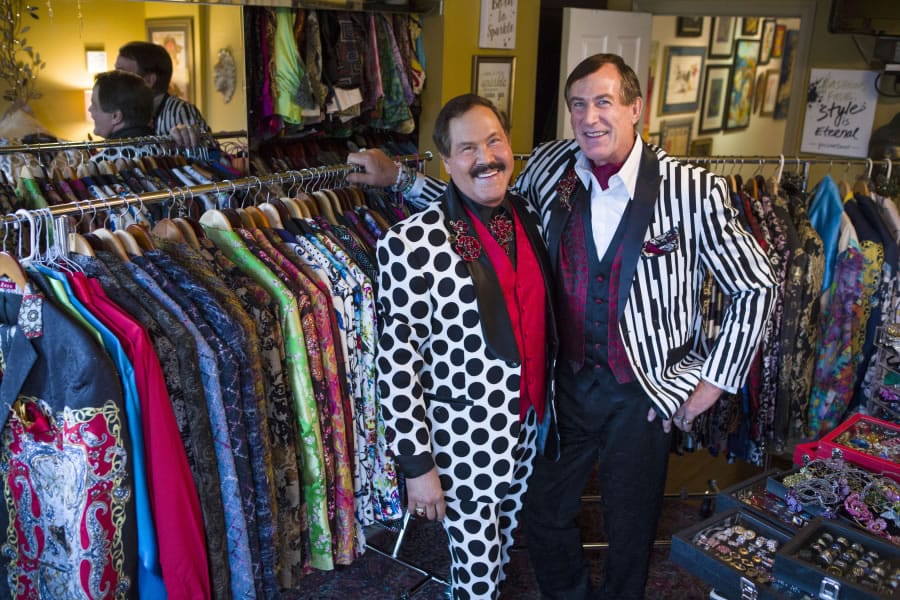 José Alberto Uclés, left, and Tom Noll in their home. They have almost 300 suit jackets between the two of them.