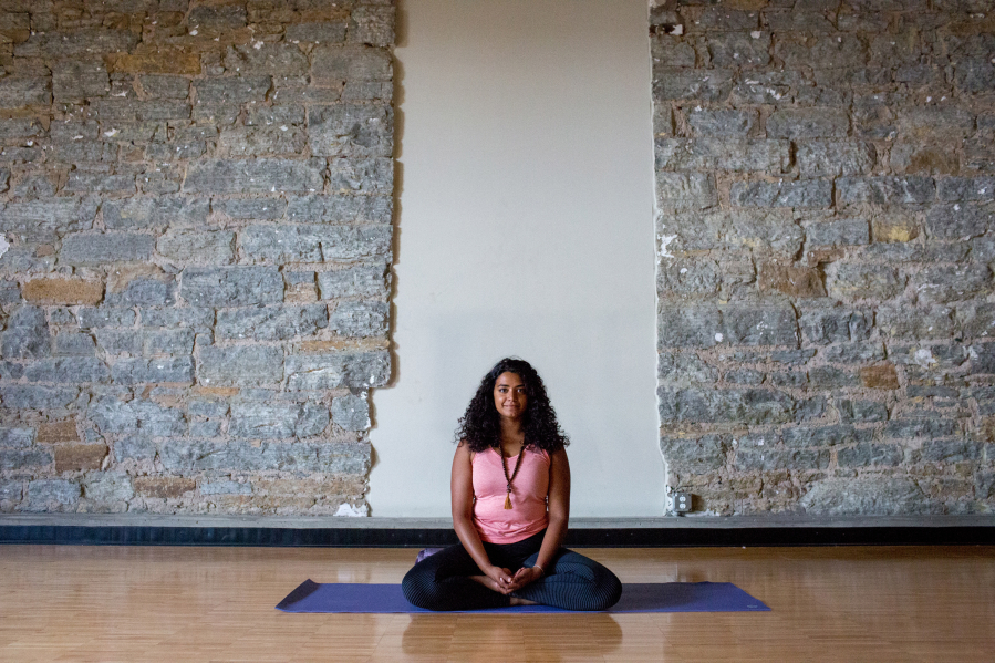 Serita Colette, who leads yoga workshops for women of color, demonstrates the calming Sukhasana pose.