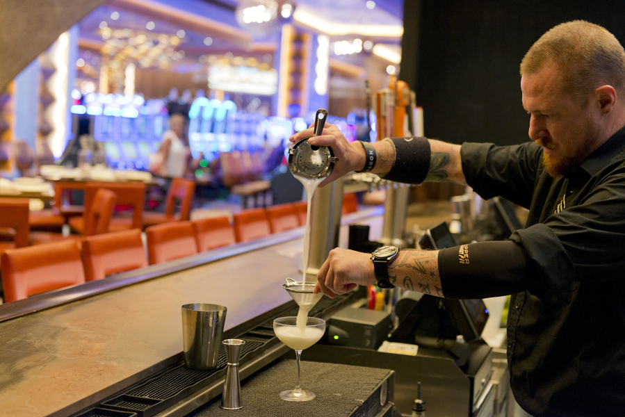 Brian Avey of Ridgefield tends bar at Michael Jordan’s Steak House at Ilani Casino Resort. About one in three jobs created in Clark County the past year fell under leisure and hospitality sectors, and more jobs are likely.