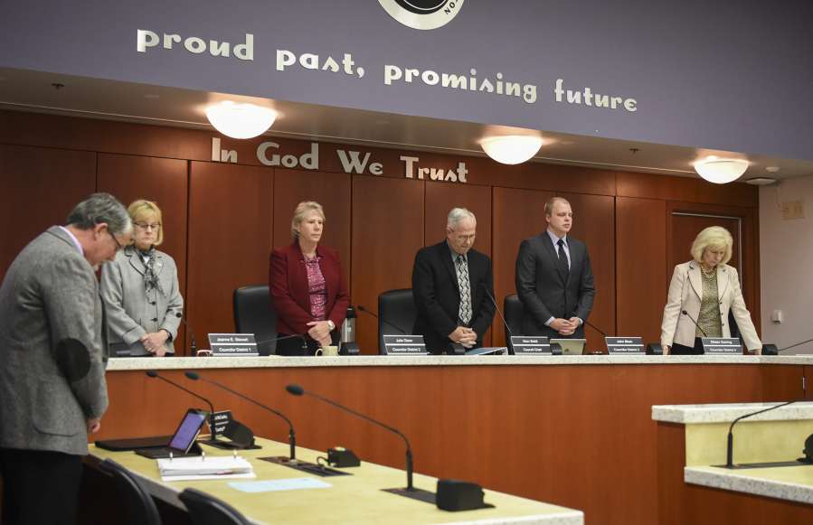 The Clark County Council observes a moment of silence before their meeting at the Public Service Building in Vancouver, Tuesday May 9, 2017.