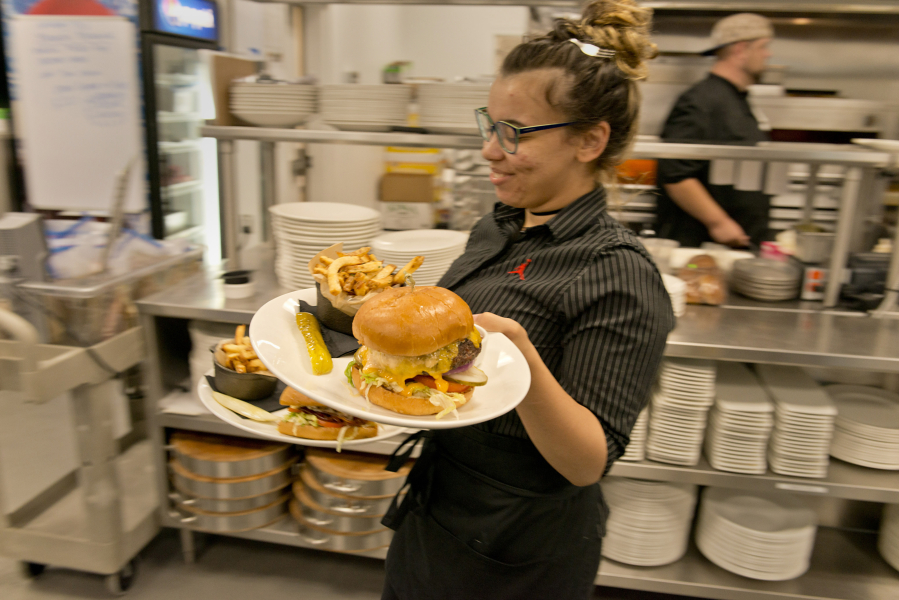 Kellie Tarquini, a server at Michael Jordan’s Steak House at Ilani Casino Resort, plates and delivers a burger special one August weekend. The sector added 1,300 jobs in the past calendar year, good for 8.5 percent growth.