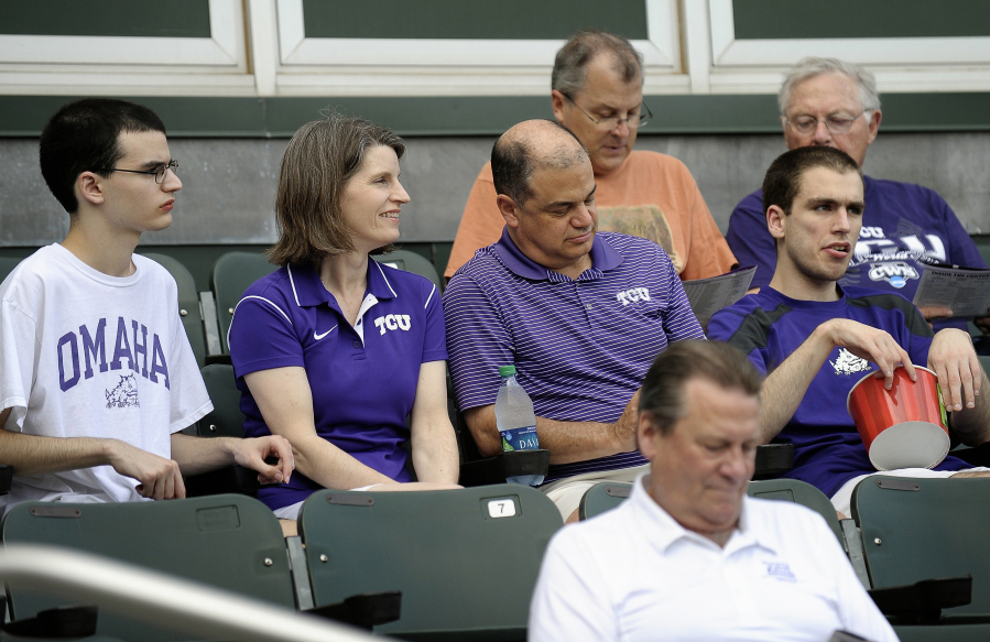 Steven Cohen, from left, Sarah Cohen, Mark Cohen, and Adam Cohen, watch the Texas Christian University-University of Texas Arlington game at Lupton Stadium on May 16 in Fort Worth, Texas. The two Cohen sons have autism. Both parents work for TCU.