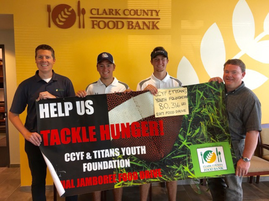 Dylan Henry, left center, and Keith Lobis, right center, are co-organizers of the Titans Youth Foundation/Clark County Youth Football Jamboree Food Drive.