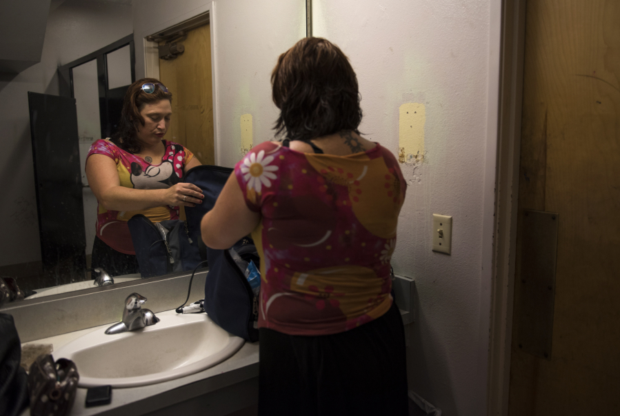 Trisha Pogue does her makeup and hair after taking a shower at Share House in downtown Vancouver in late July. The 35-year-old is homeless and usually sets up camp close to the shelter for meals and showers.