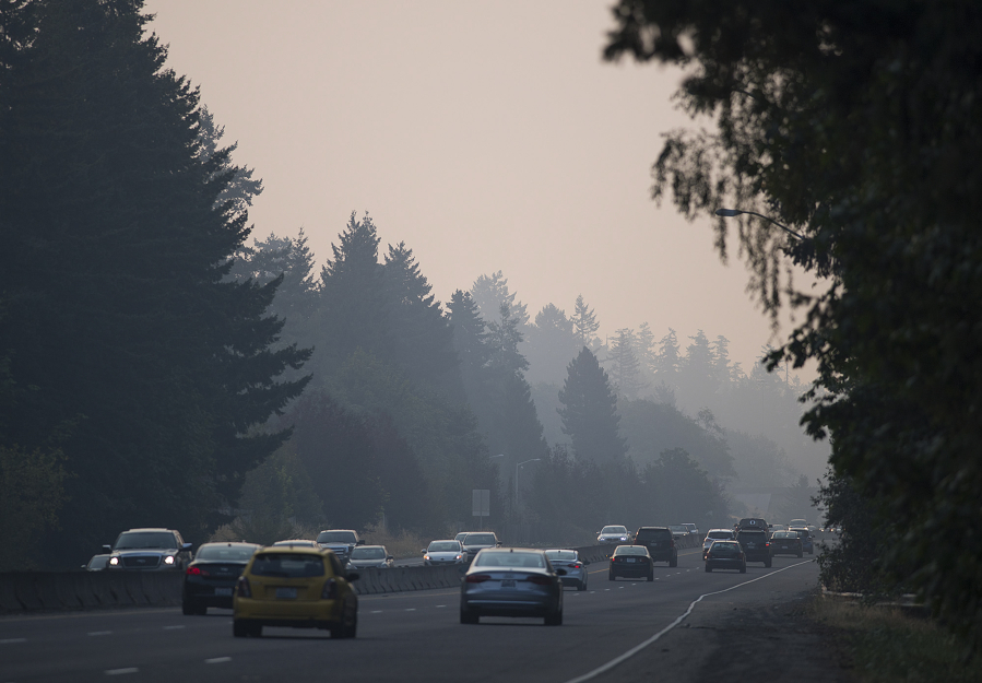 Drivers traveling along Highway 14 navigate smoky conditions during their commute while near the Lieser Road exit Thursday morning. Smoke from Canadian and Oregon wildfires combined with stagnant air conditions throughout the region are leading to thick haze in the Vancouver area.