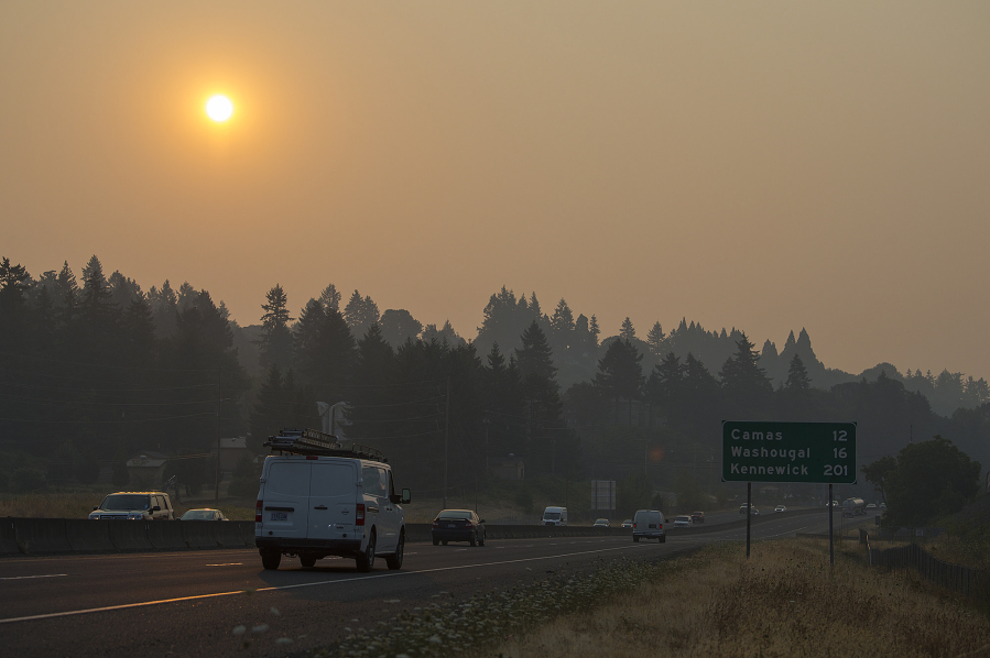 Drivers traveling along Highway 14 navigate smoky conditions during their commute Thursday morning. Smoke from Canadian and Oregon wildfires combined with stagnant air conditions throughout the region are leading to thick haze in the Vancouver area.
