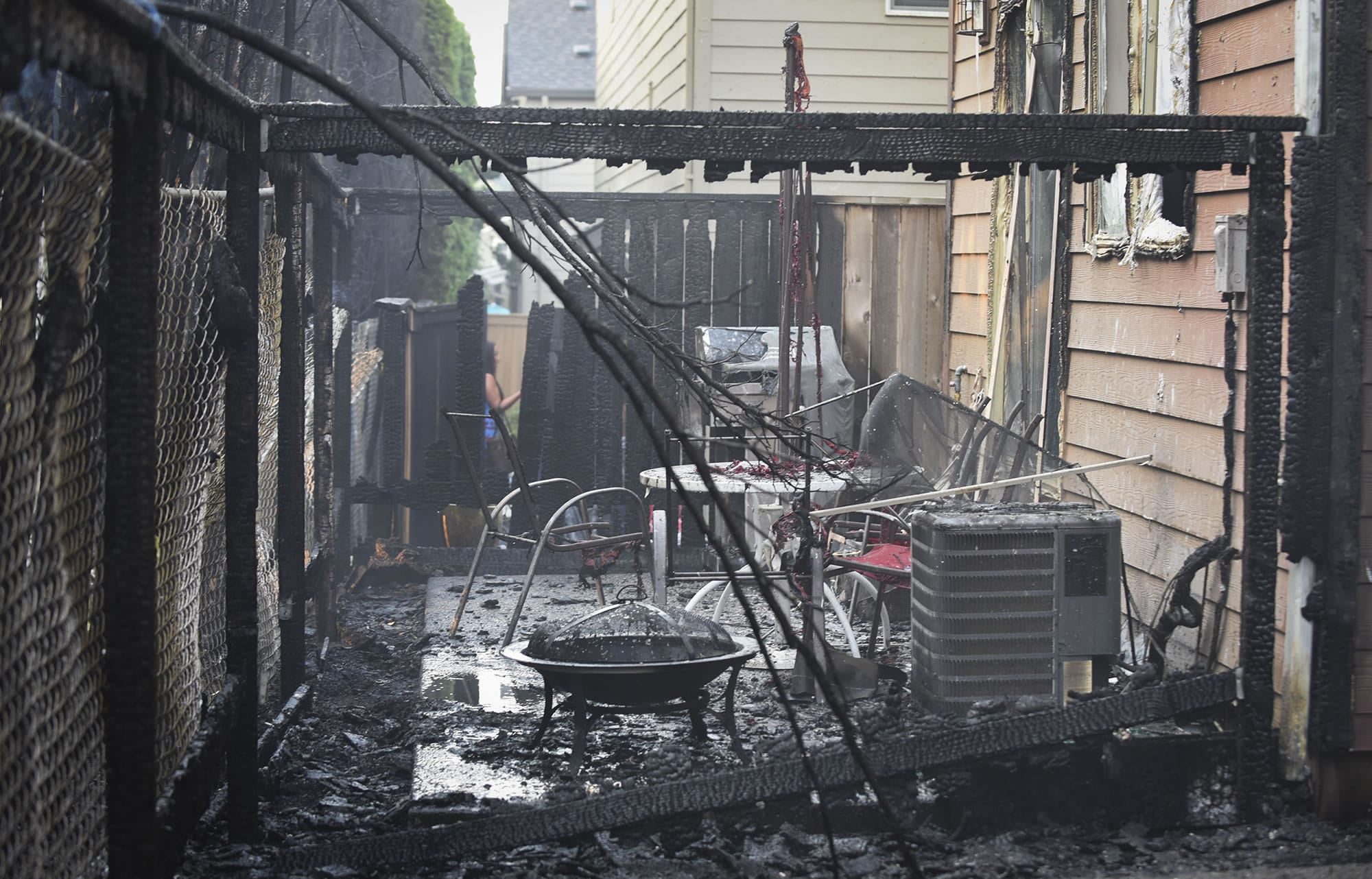 Burned patios at homes on Northeast 130th Avenue are pictured following a fire at Madison Park Apartments in Vancouver, which damaged multiple apartments and nearby homes, Thursday August 3, 2017.