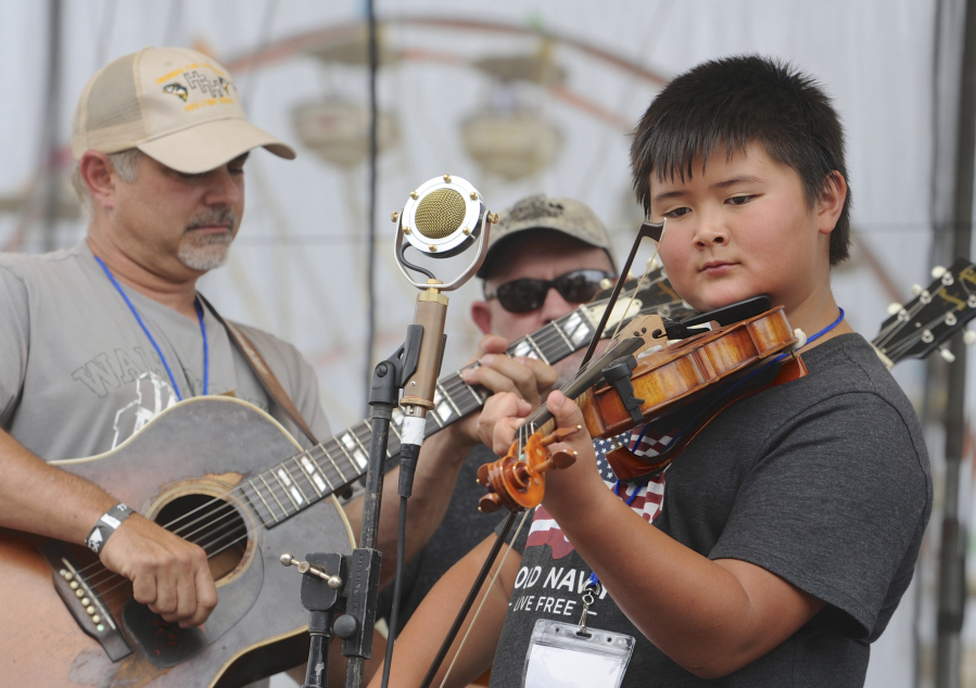 David Tormala fiddles during the Washington Old Time Fiddlers’ Association’s Washington State Fiddle Championships at the Clark County Fair Sunday. David competed in the junior-junior category, for kids 9-12 years old.