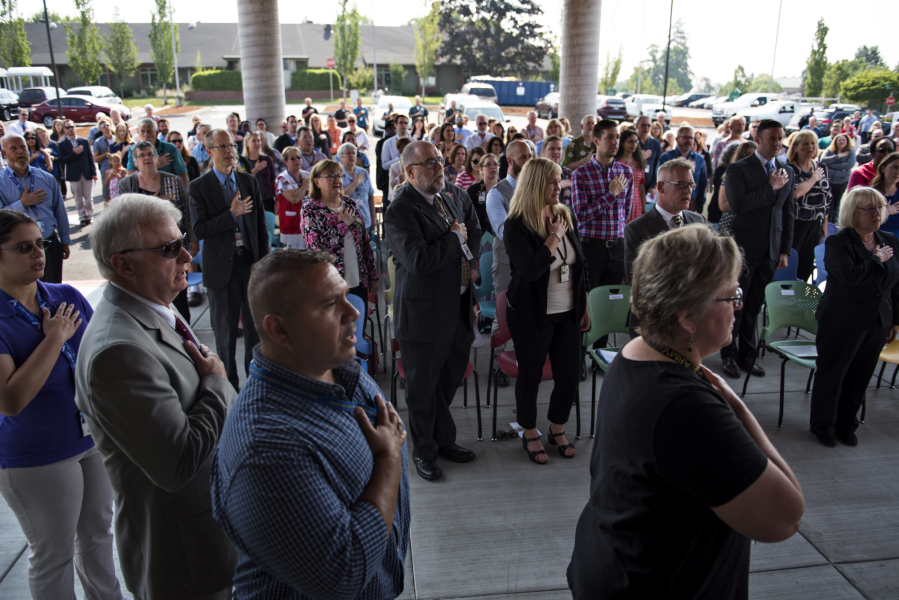 Participants join in the Pledge of Allegiance, led by four VA employees who are veterans, during Wednesday’s grand opening of the new Veterans Affairs primary care clinic in Vancouver.