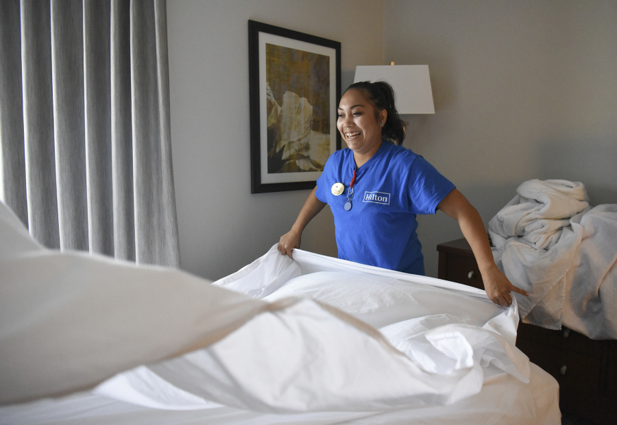 Housekeeper Noelani Iager, 32, makes a bed in a double room at Homewood Suites by Hilton in Vancouver.